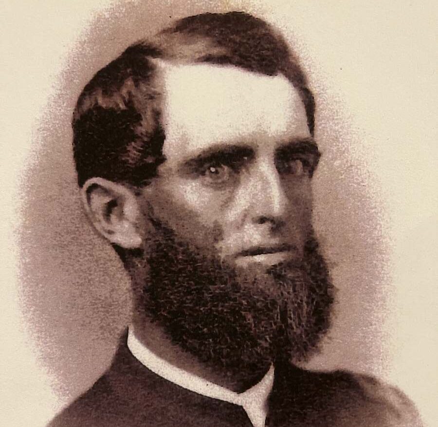 Portrait of man with thick dark beard and dark hair in uniform.