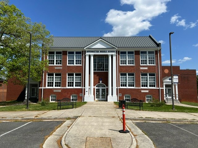 Front of brick building with white columns