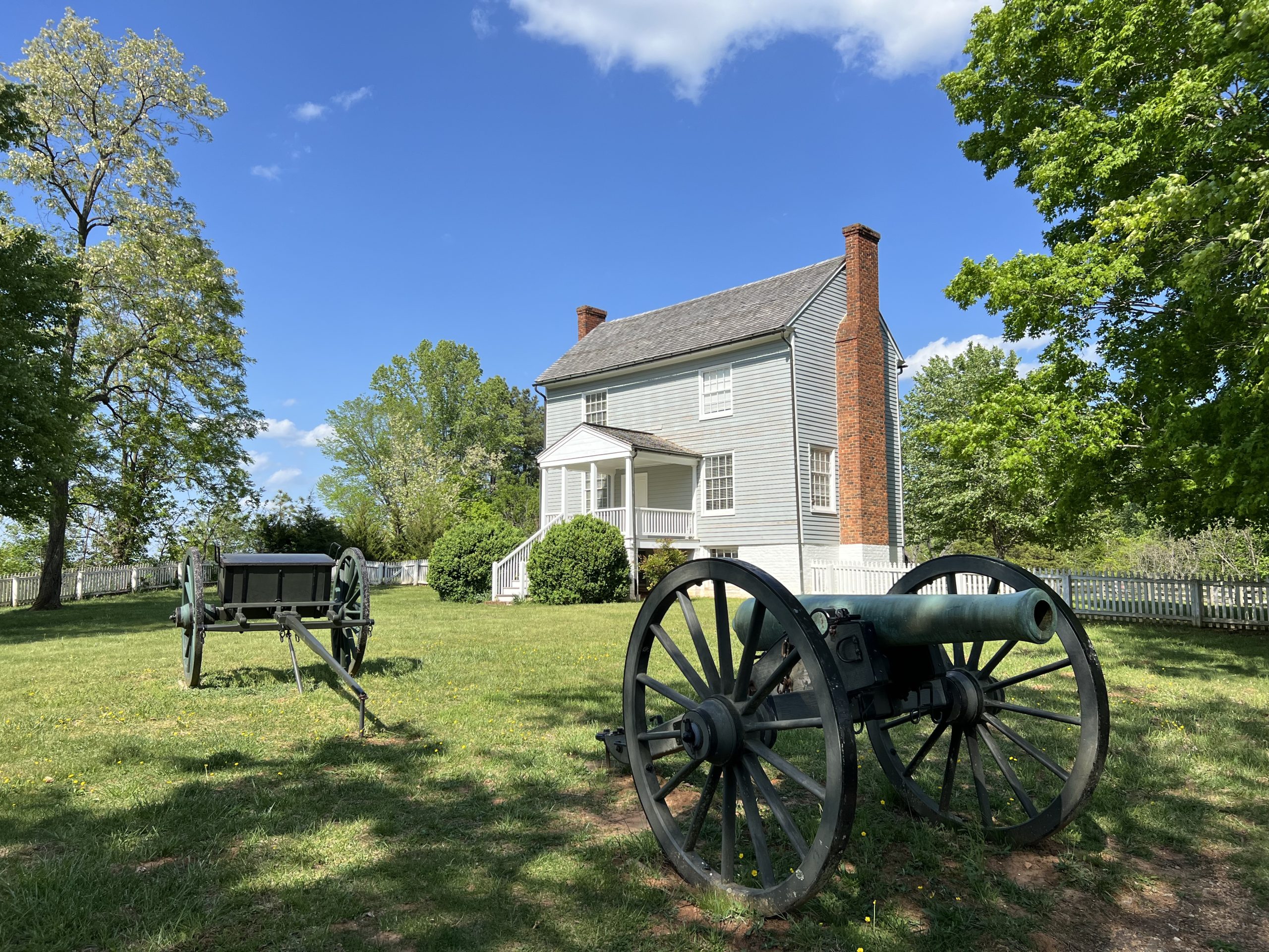 Grey house with cannon in front